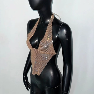 Detail of gold rhinestone mesh halter top with sparkling crystals and backless design