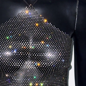 Close-up of sparkling rhinestones on black mesh halter top for party wear fashion