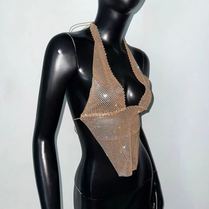 Close-up of champagne gold rhinestone mesh halter top with sparkling deep V-neck detail