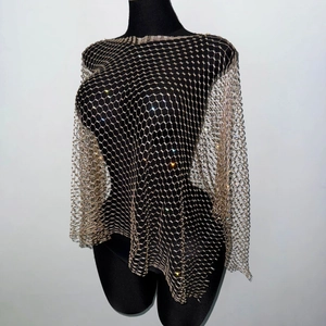 Detailed close-up of champagne gold mesh top with rhinestones on a mannequin