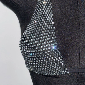 Close-up of black halter top featuring rows of sparkling silver square rhinestones