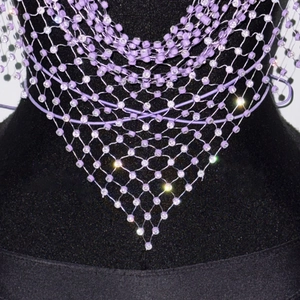 Detail van paarse mesh bodyketting met sprankelende strass-steentjes op zwarte mannequin