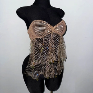 Detail of gold fishnet top with sparkling rhinestones and metal sequin fringe trim