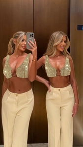 Close-up of sparkling gold sequin crop top with V-neck for club and party wear
