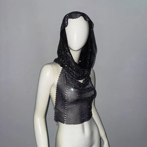 Close-up of metallic mesh crop top with hood showing silver sequins and chain texture