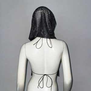 Detail of silver chainmail hooded top with lace-up back design for festival party wear