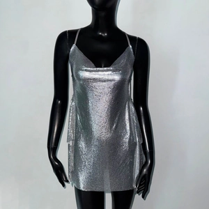Detail of silver sequin metal mesh dress with thin straps and a reflective cowl neck finish