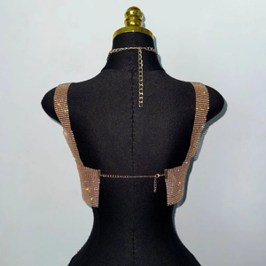 Macro shot of rose gold rhinestone body chain vest with adjustable back chains