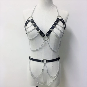 Gothic punk black leather body harness with silver layered metal chains on a mannequin