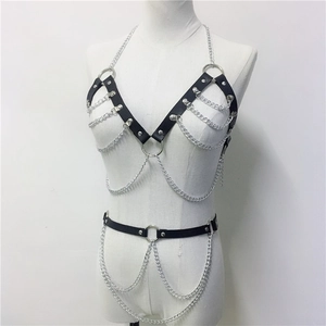 Detail of punk leather body chain set with silver metal rings and rivets