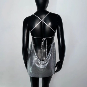 Close-up of shiny silver metallic sequin mesh fabric and cross back straps detail