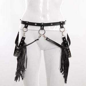 Detail of punk leather body harness featuring metal star rivets and long black fringe