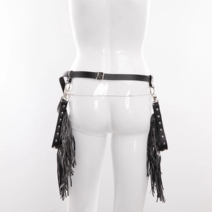 Detailed back view of a black punk leather tassel belt with metal rings and studs on a model