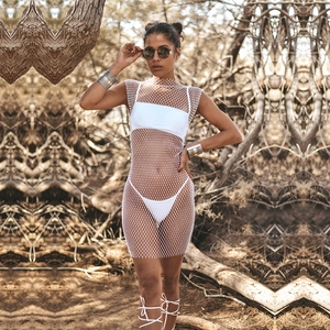 Detail of white mesh dress with sparkling rhinestones over a bikini on beach