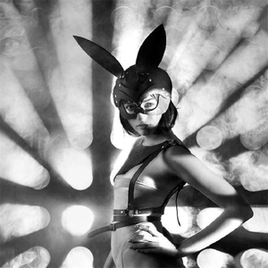 Artistic monochrome photo of studded rabbit leather mask and gothic body harness set