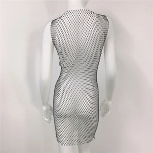 Detail shot of black mesh mini dress with sparkling rhinestones on a white mannequin