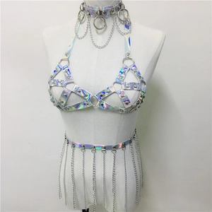 Macro detail of holographic PU leather harness set with silver chains and rivets