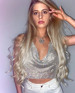 Detailed view of rhinestone butterfly necklace and shiny sequin halter crop top