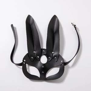 Detail of black leather bunny mask featuring silver metal studs and adjustable buckle straps