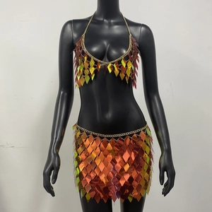 Detail of holographic sequin bra and mini skirt set with gold chain links on mannequin