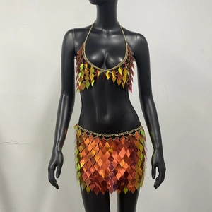 Close-up of rainbow sequin two-piece festival set with metal chains on a mannequin