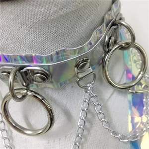 Detail of holographic punk choker featuring metallic silver rings and hanging chain links