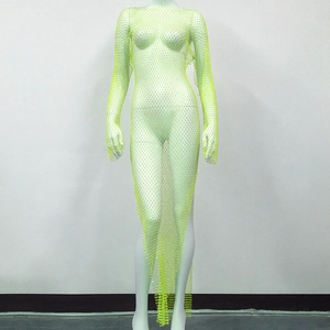 Macro detail of sheer mesh fabric with glittering rhinestones on neon green dress