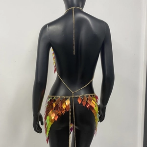 Detail of colorful sequin body chain and mini skirt set on a black model mannequin