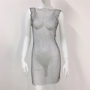 Detailed view of black mesh dress with shimmering rhinestones and hollow-out fishnet texture