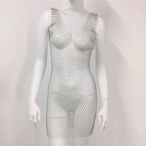 Detailed close-up of sparkling silver rhinestone mesh and hollow net structure fabric