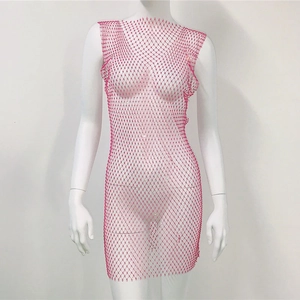Close-up of pink rhinestone mesh dress detail with sparkling crystals on elastic fabric
