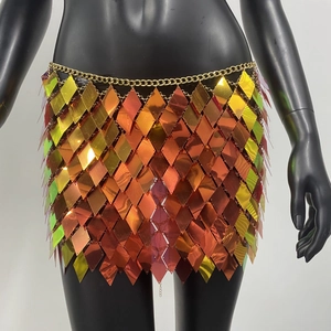 Detailed macro view of orange gradient metallic diamond sequins on a sequin mini skirt