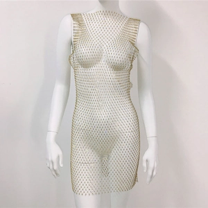 Detail of gold fishnet dress featuring sparkling rhinestones and hollow mesh texture