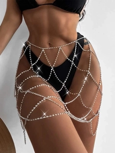 Detailed view of silver rhinestone body chain skirt with intricate hollow mesh design