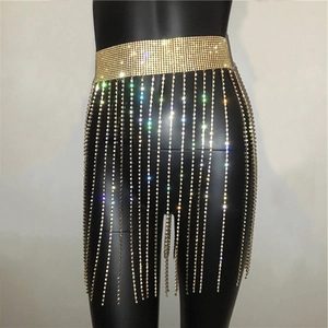 Detailed close-up of a sparkling gold rhinestone fringe mini skirt for party wear