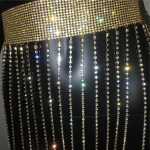 Detail of luxurious gold mesh waist chain with sparkling rhinestones and cascading fringes