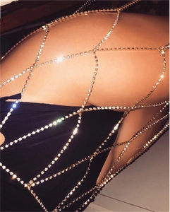 Macro detail of gold mesh body chain with sparkling rhinestones for party wear