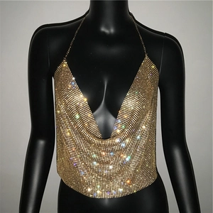 Detail view of the shimmering gold sequin mesh and delicate halter metal chain