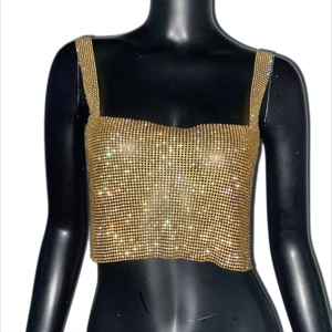 Close-up of luxury gold rhinestone crop top featuring a sparkling mesh pattern and square neck