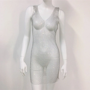 Detail of silver fishnet mesh dress with shimmering rhinestones and a deep V-neckline