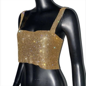 Detail of gold rhinestone tank top showing intricate crystal mesh and shimmering finish