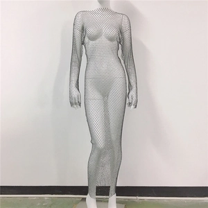 Detailed close-up of sexy black fishnet maxi dress with sparkling rhinestone mesh patterns