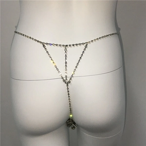 Detailed macro view of sparkling rhinestone T-back body chain with silver metal link waist