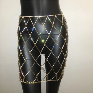 Close-up of sparkling rhinestone gold body chain skirt with hollow grid mesh design