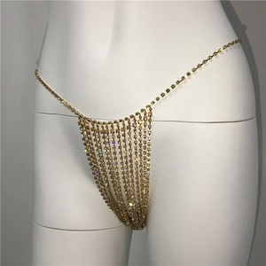 Detailed view of layered gold rhinestone body chain with shimmering tassels for beachwear