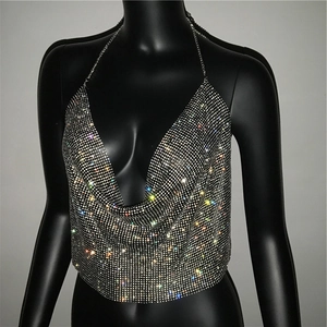 Macro detail of silver rhinestone halter top showing sparkling mesh texture and V-neck