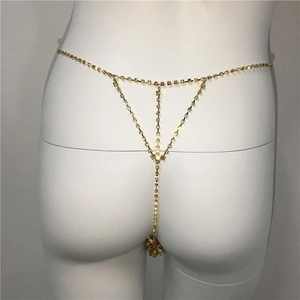 Detail of gold rhinestone body chain featuring sparkling crystal T-shaped waist link