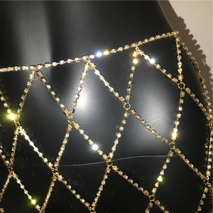 Macro detail of sparkling gold rhinestone mesh skirt featuring a luxury hollow pattern