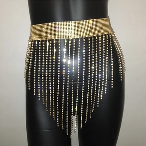 Detailed close-up of golden rhinestone fringe waist chain with shimmering V-shaped tassels
