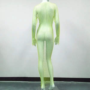 Détail d'une robe résille vert fluo avec strass étincelants et manches longues amples
